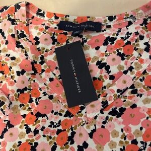 This is a high quality shirt with beautiful flowers, seemingly dancing on it.